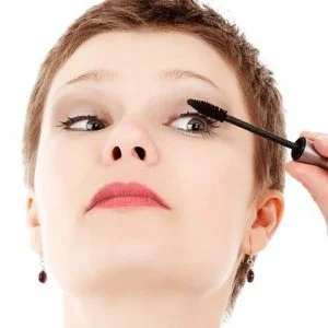 Image of a female applying mascara on her eyelashes