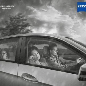 Male driving in car with glasses on