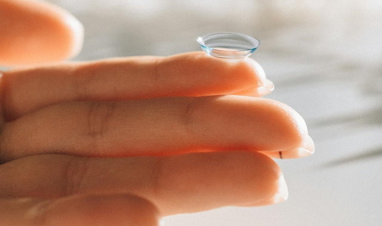 Image of a hand holding a contact lens