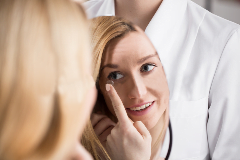 Image of a female applying a contact lenses