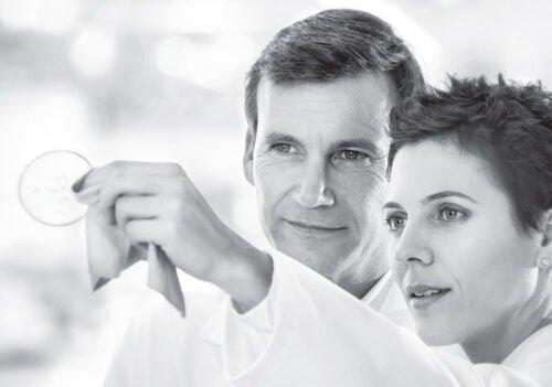 Image of two people looking through a spectacle lens