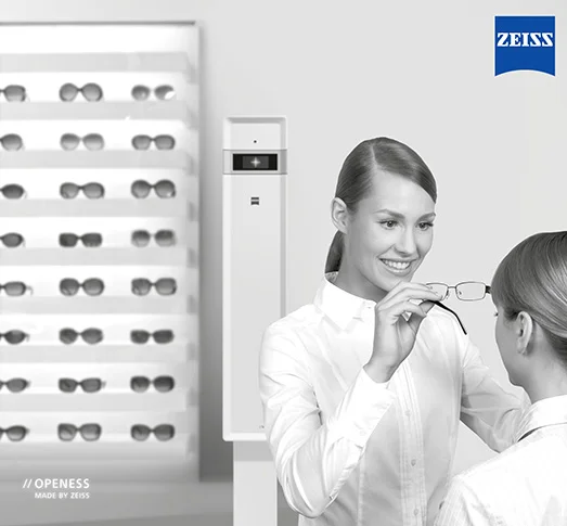 Image of an optician putting glasses on someone